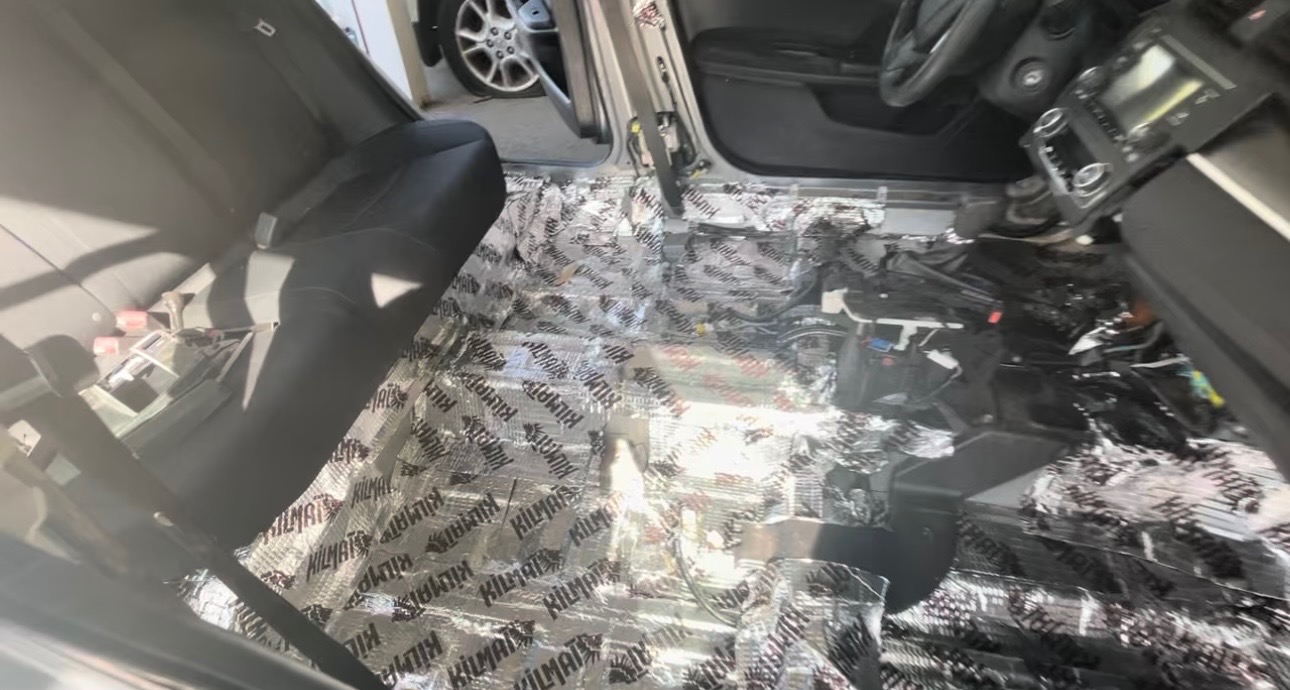Seats removed to lay sound insulation and wiring cleanly.